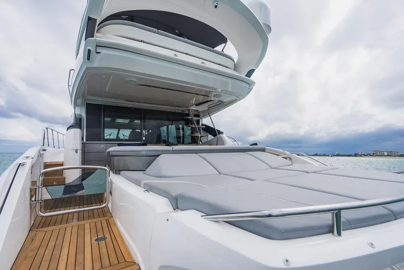 Slide: The Image of 2022 Princess S66 yacht with spacious deck and luxurious seating, under a cloudy sky. - 40