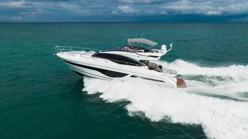 Slide: The Image of 2022 Princess S66 yacht cruising on open sea under cloudy skies. - 7