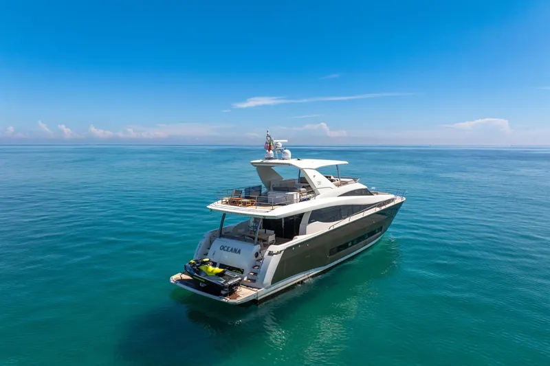 Slide: The Image of Luxurious 2015 Prestige 750 yacht cruising on calm, clear blue ocean waters. - 1