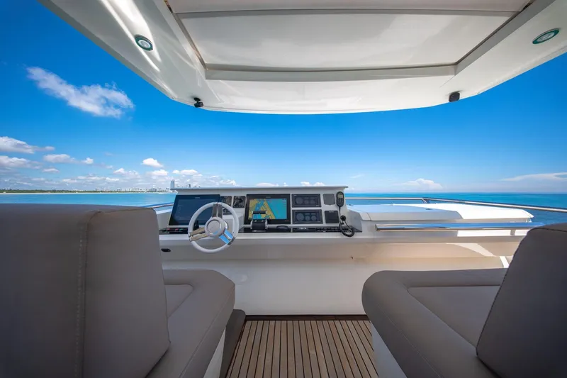 Slide: The Image of Prestige 750 yacht helm, 2015 model, with ocean view and modern navigation equipment. - 11