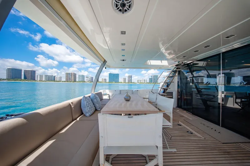 Slide: The Image of Luxurious 2015 Prestige 750 yacht deck with seating, table, and ocean view. - 24