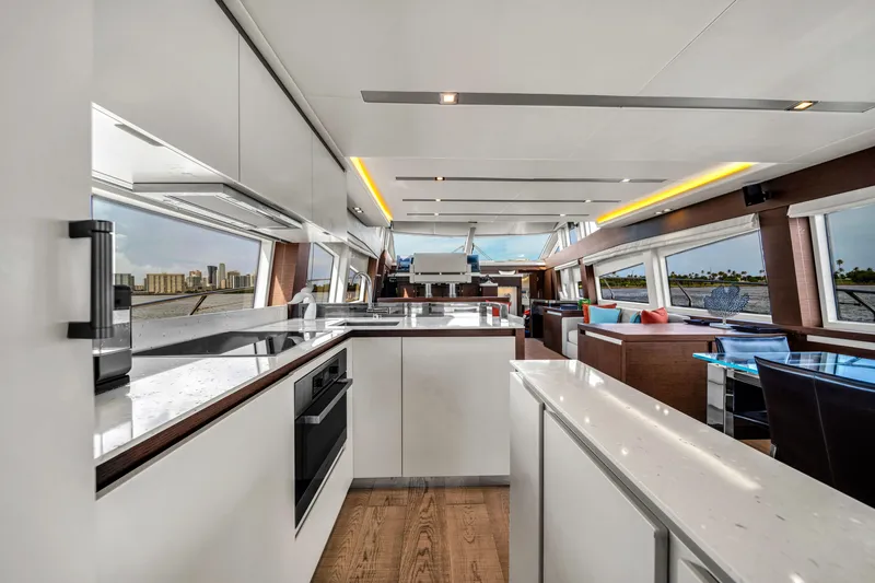 Slide: The Image of Luxurious interior of a 2015 Prestige 750 yacht with modern kitchen and panoramic windows. - 28