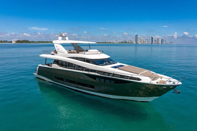Slide: The Image of Luxurious 2015 Prestige 750 yacht cruising on clear blue waters near a city skyline. - 3