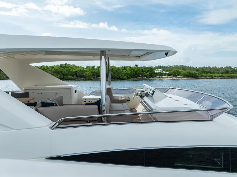Slide: The Image of Luxury 2015 Prestige 750 yacht with sleek design, cruising near lush green shoreline. - 4