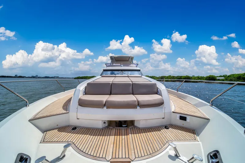 Slide: The Image of Luxury Prestige 750 yacht deck with sun loungers, 2015 model, under a clear blue sky. - 7