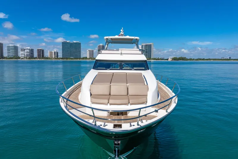 Slide: The Image of Luxurious 2015 Prestige 750 yacht on calm waters with city skyline backdrop. - 84