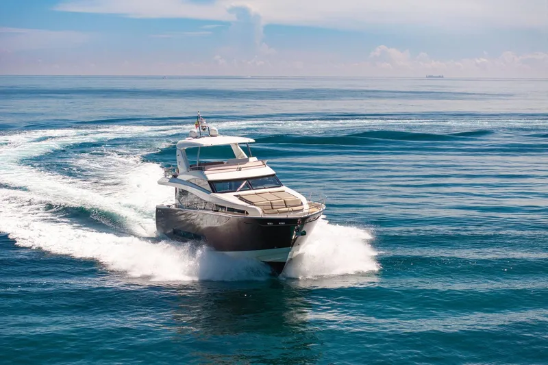 Slide: The Image of Luxury 2015 Prestige 750 yacht cruising on open sea under clear skies. - 92