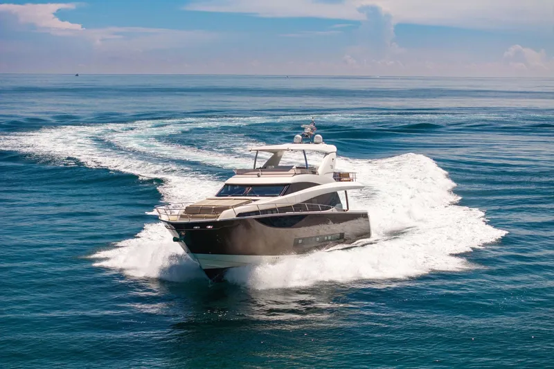 Slide: The Image of Luxurious 2015 Prestige 750 yacht cruising on open sea under clear skies. - 93