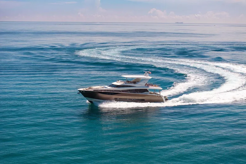 Slide: The Image of Luxurious 2015 Prestige 750 yacht cruising on open sea, creating elegant water trails. - 94