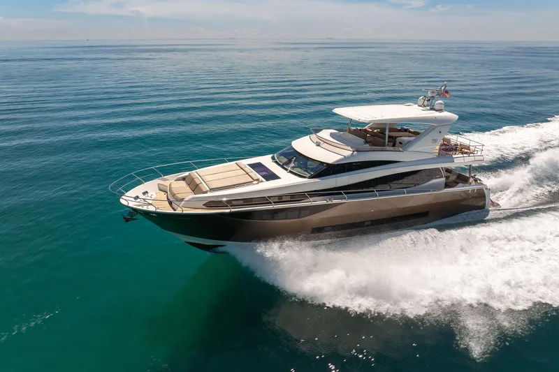 Slide: The Image of Luxury 2015 Prestige 750 yacht cruising on clear blue ocean waters. - 96