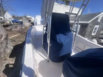 Slide: The Image of 2002 Grady-White Escape 209 boat with blue covers, docked outdoors. - 11