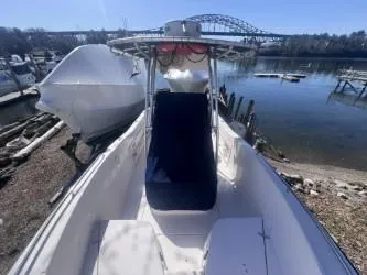 Slide: The Image of 2002 Grady-White Escape 209 boat docked by a scenic waterfront with bridge view. - 14