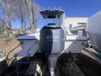 Slide: The Image of 2002 Grady-White Escape 209 boat with 200 horsepower engine, parked outdoors. - 3