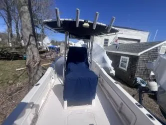 Slide: The Image of 2002 Grady-White Escape 209 boat with blue cover, docked outdoors. - 6