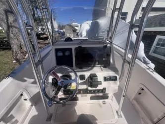 Slide: The Image of 2002 Grady-White Escape 209 boat console with steering wheel and controls. - 7