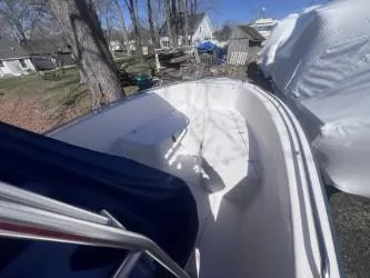 Slide: The Image of 2002 Grady-White Escape 209 boat, docked outdoors, surrounded by trees and covered structures. - 8