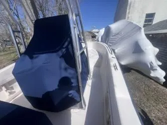 Slide: The Image of 2002 Grady-White Escape 209 boat with blue cover, parked outdoors. - 9