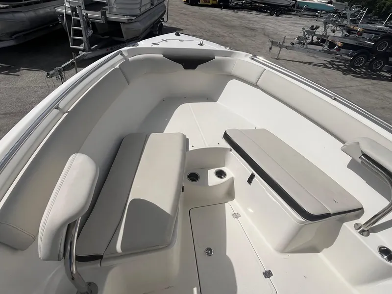 Slide: The Image of 2022 Sailfish 242 CC boat interior with cushioned seating and storage compartments. - 10