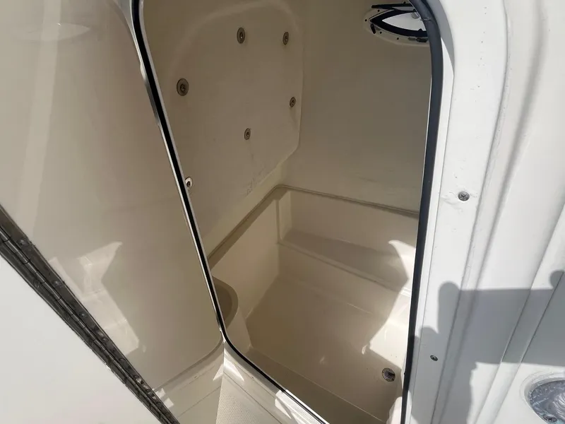 Slide: The Image of Interior view of 2022 Sailfish 242 CC boat compartment, showcasing spacious design and clean finish. - 11