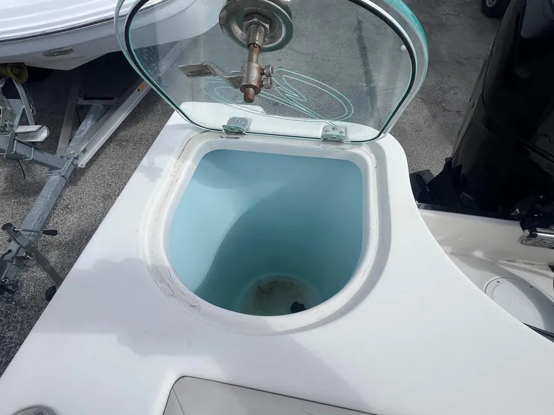 Slide: The Image of Livewell on 2022 Sailfish 242 CC boat with open lid and faucet. - 6