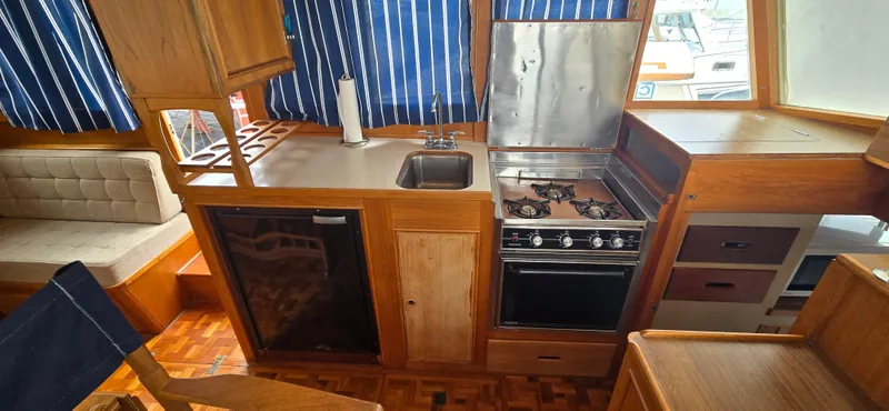 Slide: The Image of Interior of 1987 Grand Banks 36 Classic yacht with kitchen and seating area. - 33