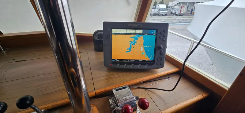 Slide: The Image of Navigation system on 1987 Grand Banks 36 Classic boat dashboard, displaying nautical chart. - 35