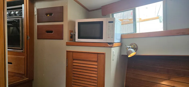 Slide: The Image of Interior of 1987 Grand Banks 36 Classic with microwave and wooden cabinetry. - 40