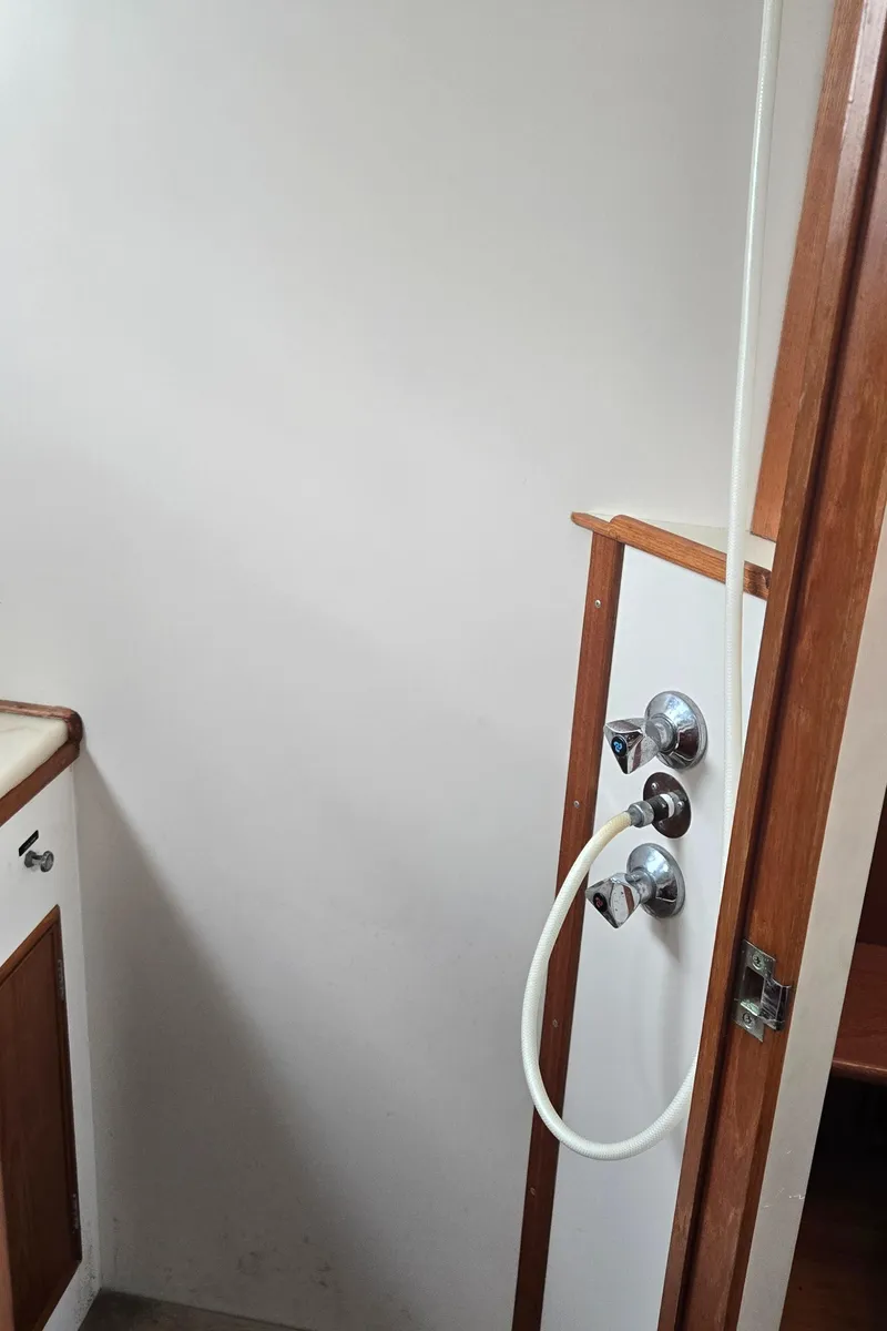 Slide: The Image of 1987 Grand Banks 36 Classic yacht interior shower area with wooden trim. - 43