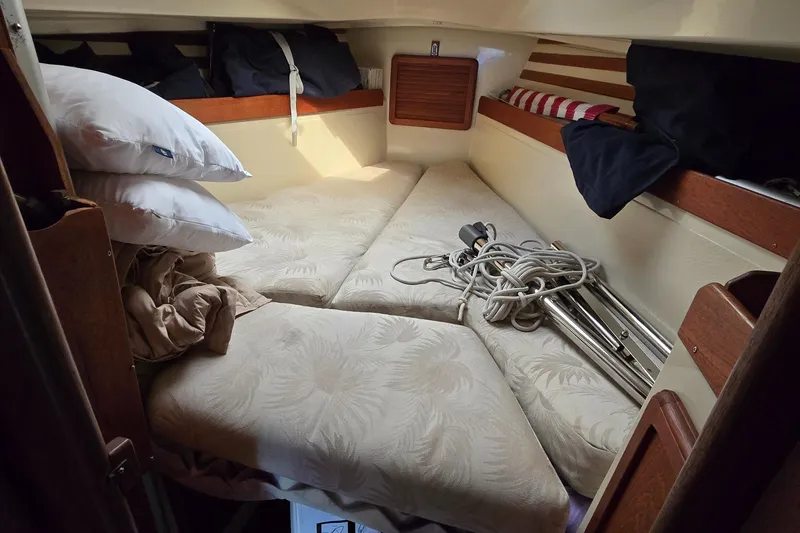 Slide: The Image of Cozy cabin interior of 1985 Mirage Yachts 35 with cushions and nautical equipment. - 4