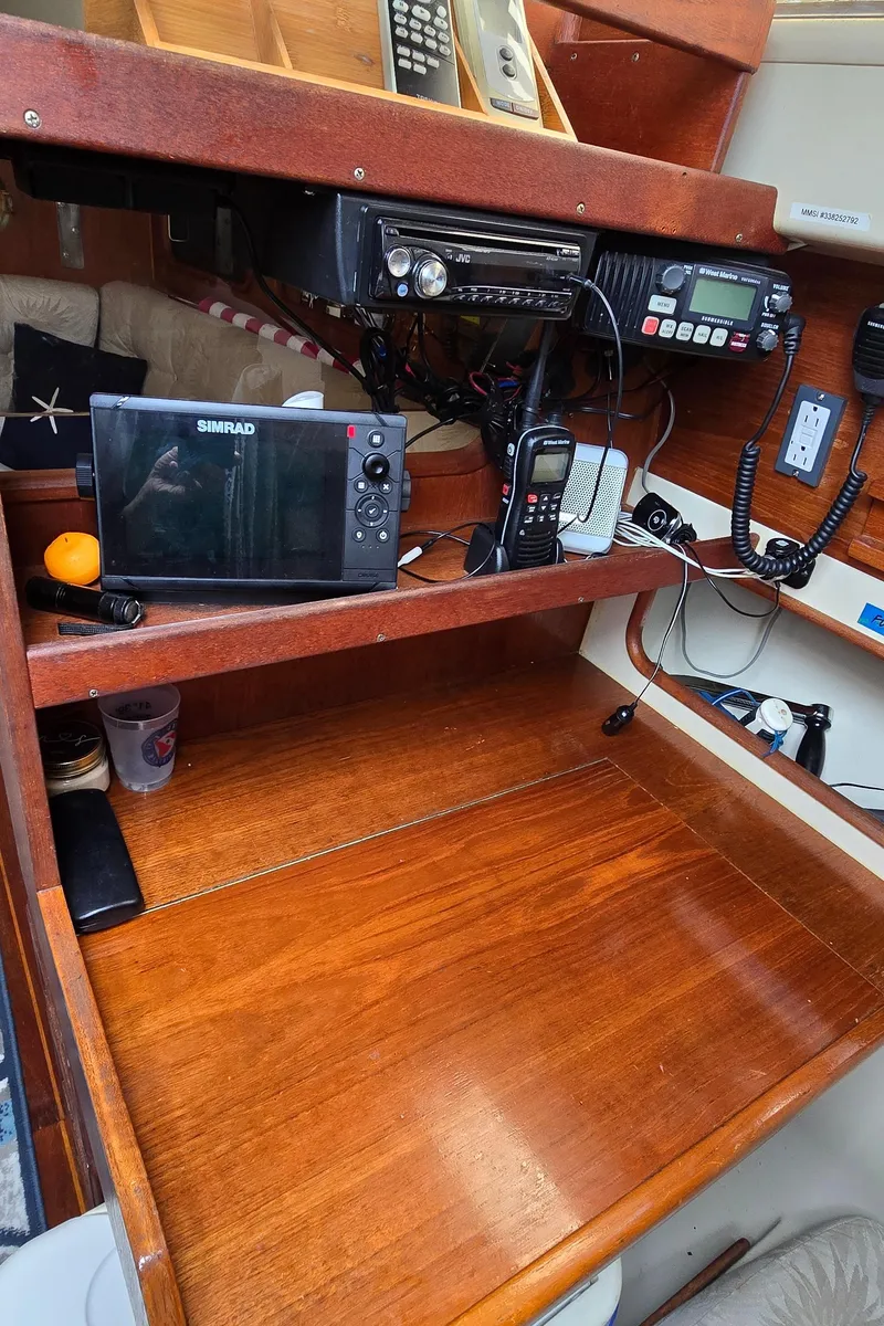Slide: The Image of Navigation station on a 1985 Mirage Yachts 35, featuring electronic equipment and wooden finish. - 6