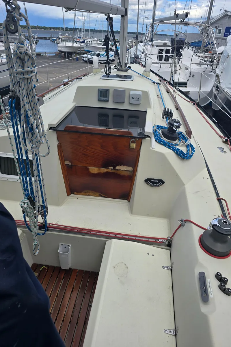 Slide: The Image of 1985 Mirage Yachts 35 sailboat deck with ropes and wooden hatch. - 7