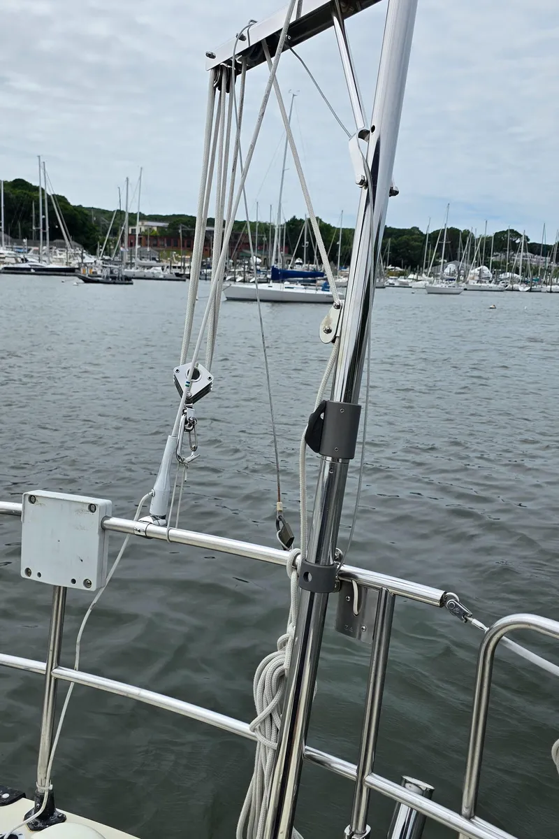 Slide: The Image of Sailboat rigging on 1985 Mirage Yachts 35, docked in a marina with other boats. - 9