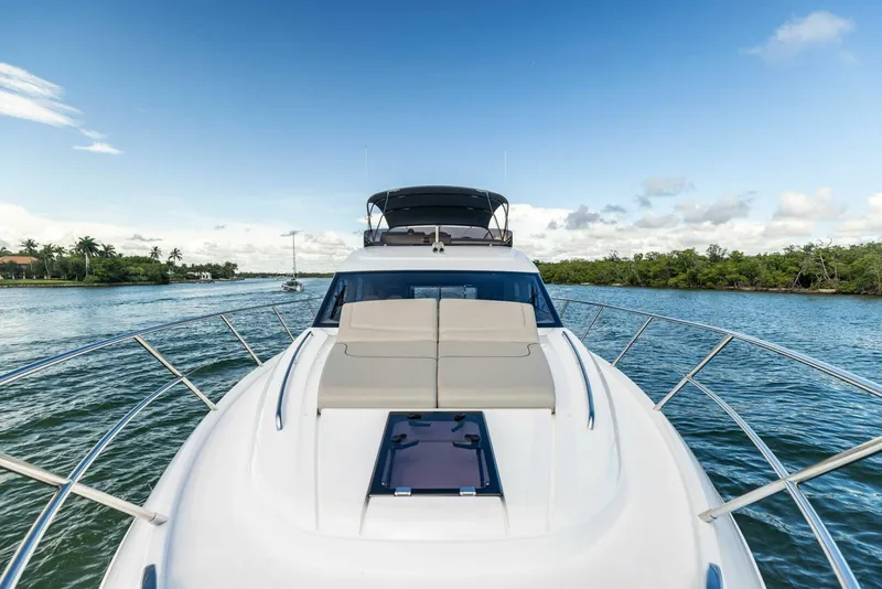 Slide: The Image of 2025 Princess F50 yacht cruising on a serene waterway under a clear blue sky. - 2