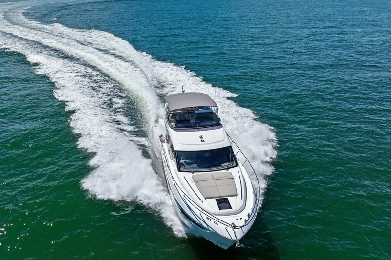 Slide: The Image of Luxurious 2025 Princess F50 yacht cruising on open water, leaving a trail of white waves. - 46