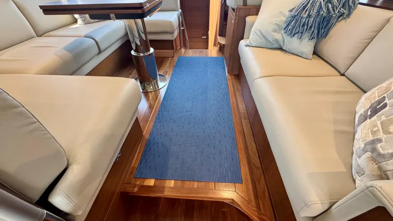 Slide: The Image of Luxurious interior of 2025 Princess F50 yacht with wooden flooring and beige seating. - 5