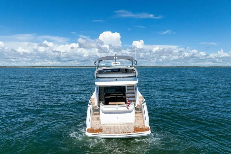 Slide: The Image of 2025 Princess F50 yacht cruising on open sea under clear blue sky. - 50