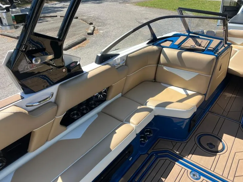 Slide: The Image of 2021 Moomba Makai boat interior with tan seating and blue accents. - 15