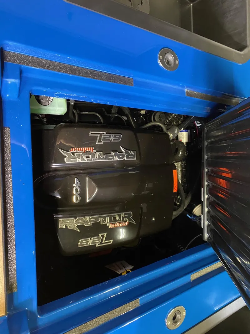 Slide: The Image of 2021 Moomba Makai engine compartment with Raptor 6.2L motor, blue exterior. - 17