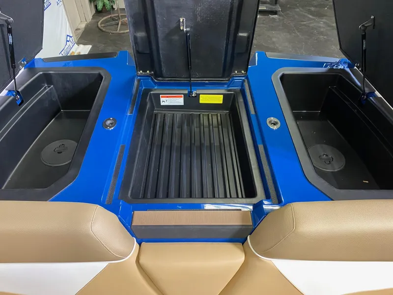 Slide: The Image of 2021 Moomba Makai boat storage compartments with blue and tan interior. - 19