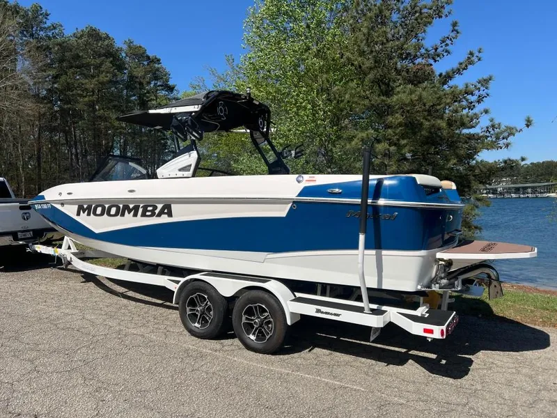 Slide: The Image of 2021 Moomba Makai boat on trailer by lake, surrounded by trees. - 3
