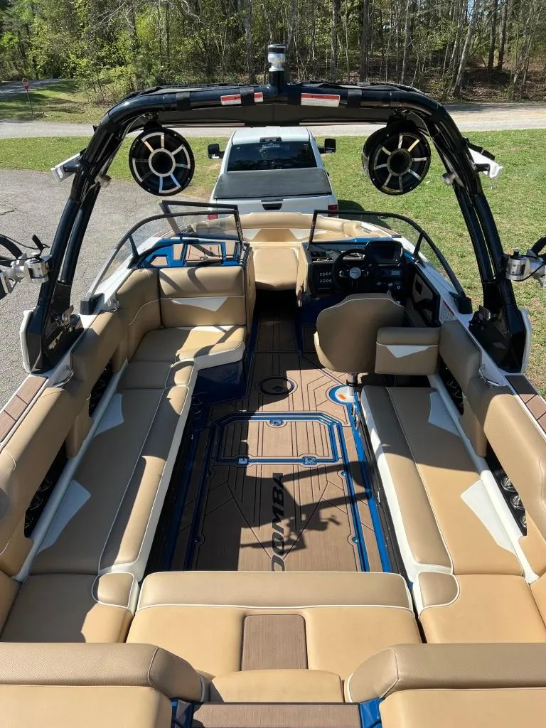 Slide: The Image of 2021 Moomba Makai boat interior with tan seating and modern dashboard. - 9