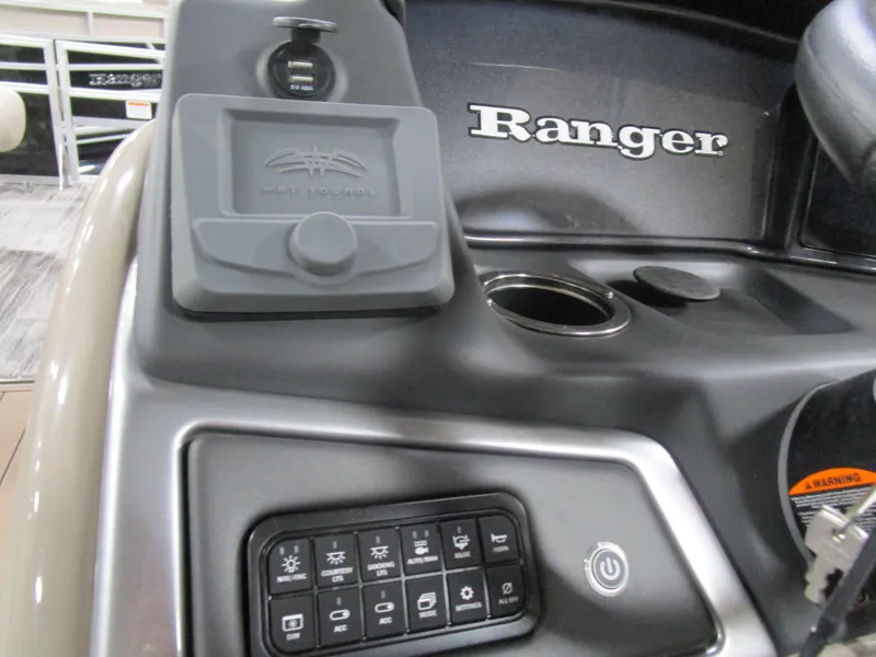 Slide: The Image of Control panel of 2025 Ranger 223 FC boat with switches and cup holder. - 10