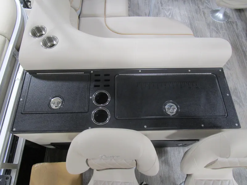 Slide: The Image of 2025 Ranger 223 FC boat interior with seating, cup holders, and storage compartments. - 13