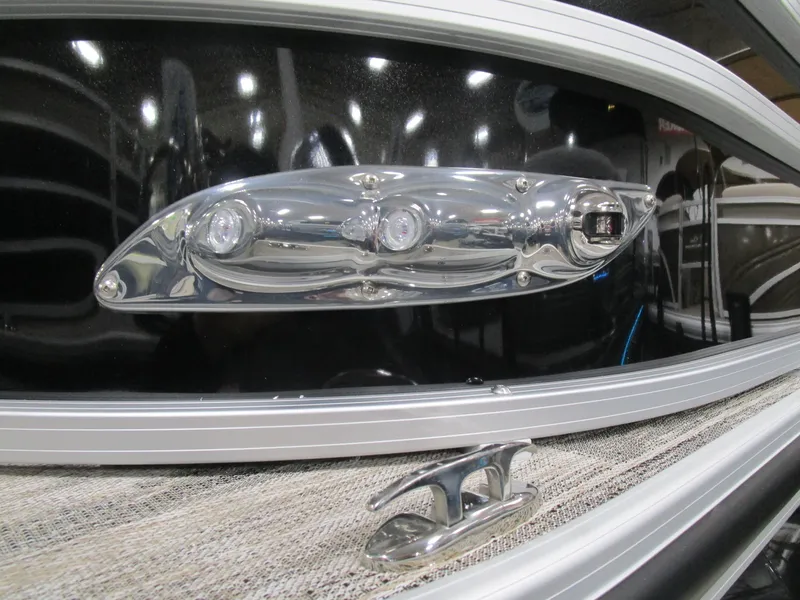 Slide: The Image of 2025 Ranger 223 FC boat detail with chrome fixtures and sleek design. - 2