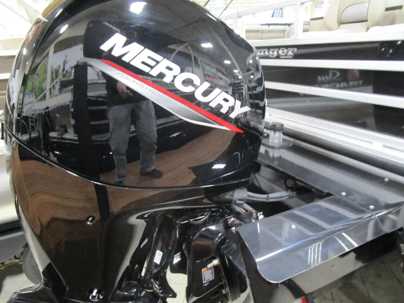 Slide: The Image of 2025 Ranger 223 FC boat with Mercury outboard motor in showroom. - 21