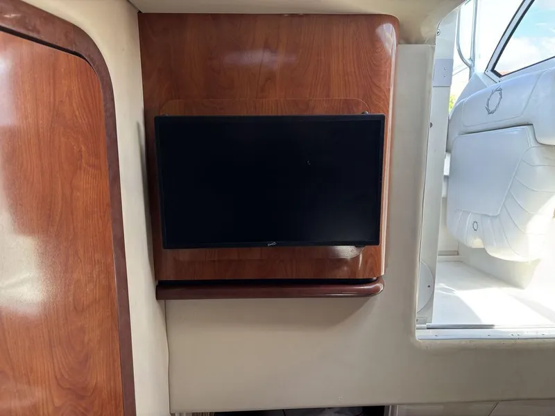 Slide: The Image of 2008 Fountain 33 Sportfish Cruiser interior with mounted TV and wooden paneling. - 19