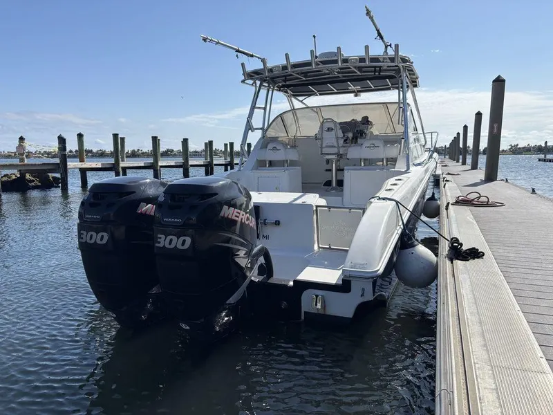 Slide: The Image of 2008 Fountain 33 Sportfish Cruiser with twin Mercury 300 engines docked at marina. - 2