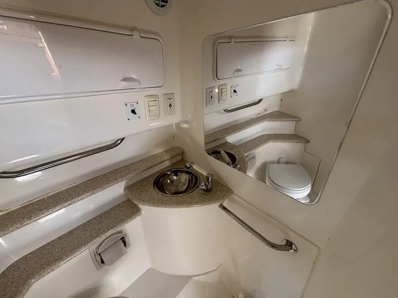 Slide: The Image of 2008 Fountain 33 Sportfish Cruiser bathroom with sink, mirror, and toilet. - 22