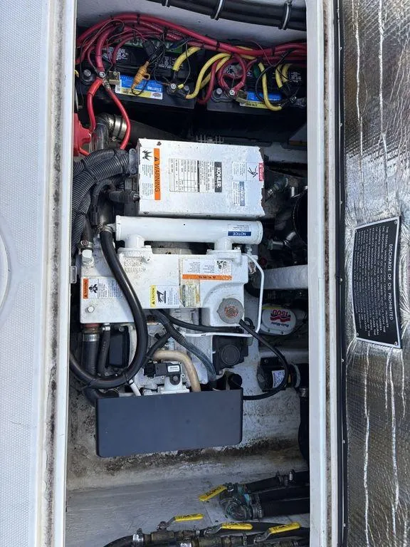 Slide: The Image of 2008 Fountain 33 Sportfish Cruiser engine compartment with wiring and components. - 25