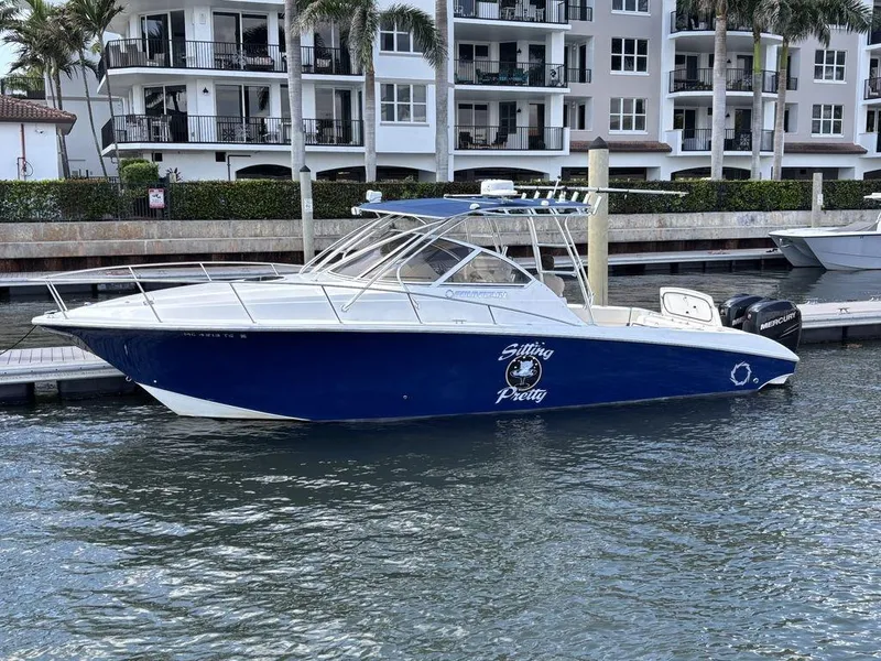 Slide: The Image of 2008 Fountain 33 Sportfish Cruiser docked near waterfront apartments. - 29